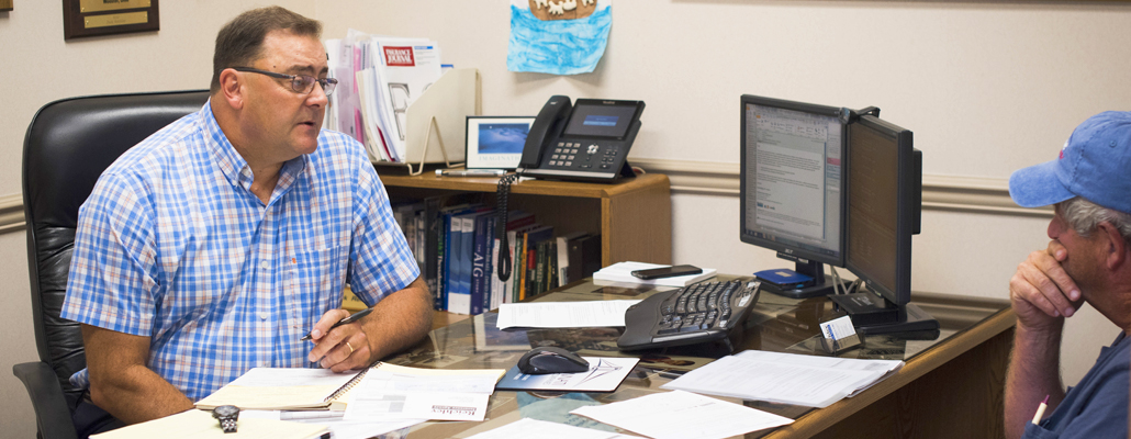 Perk Reichlety in the office talking to a client